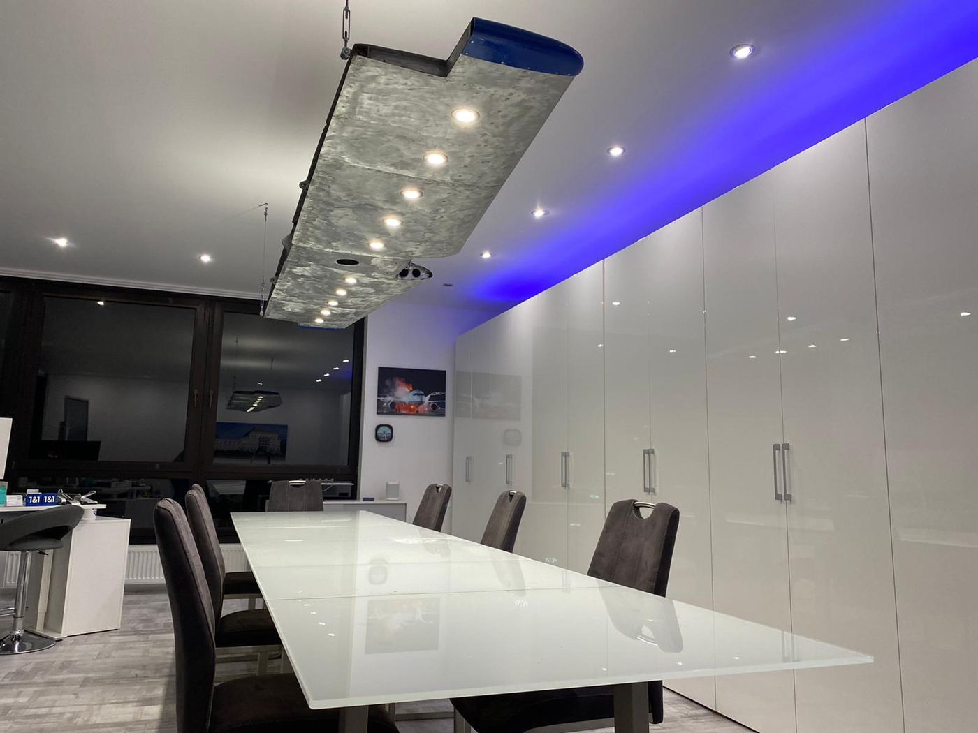 An aircraft wing turned into a ceiling light above a dining table