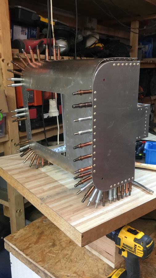 Clecoed: Every panel is pinned with clecos first, the way aircraft skins are, before a single rivet goes in.