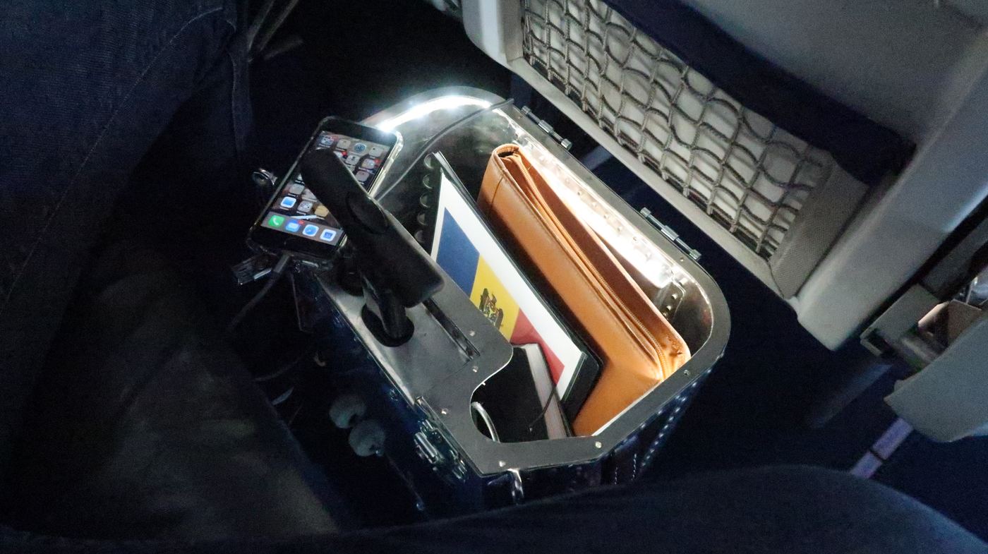 The Taildragger open under an aircraft seat, lit from inside